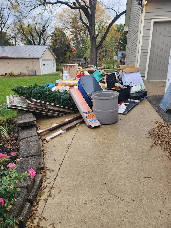 Dumpster being loaded with debris for Residential Dumpster Rental in Alva
